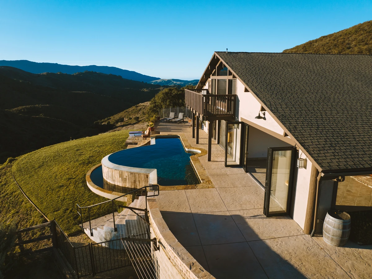 Expansive wraparound deck with panoramic valley views, perfect for ceremony and reception spaces