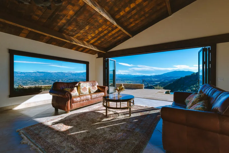 Open-concept living space with floor-to-ceiling windows framing Santa Ynez Valley views