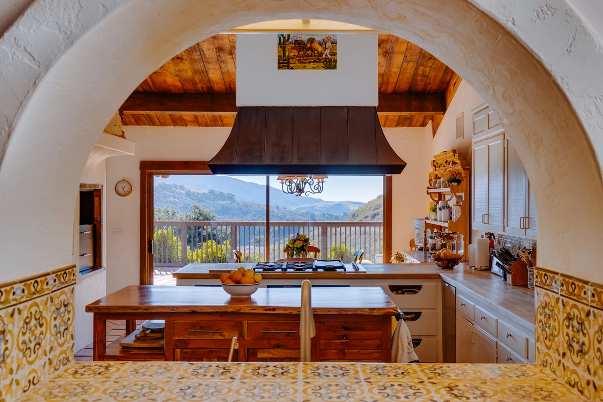 Spacious bedroom with queen bed and modern mountain design featuring valley views