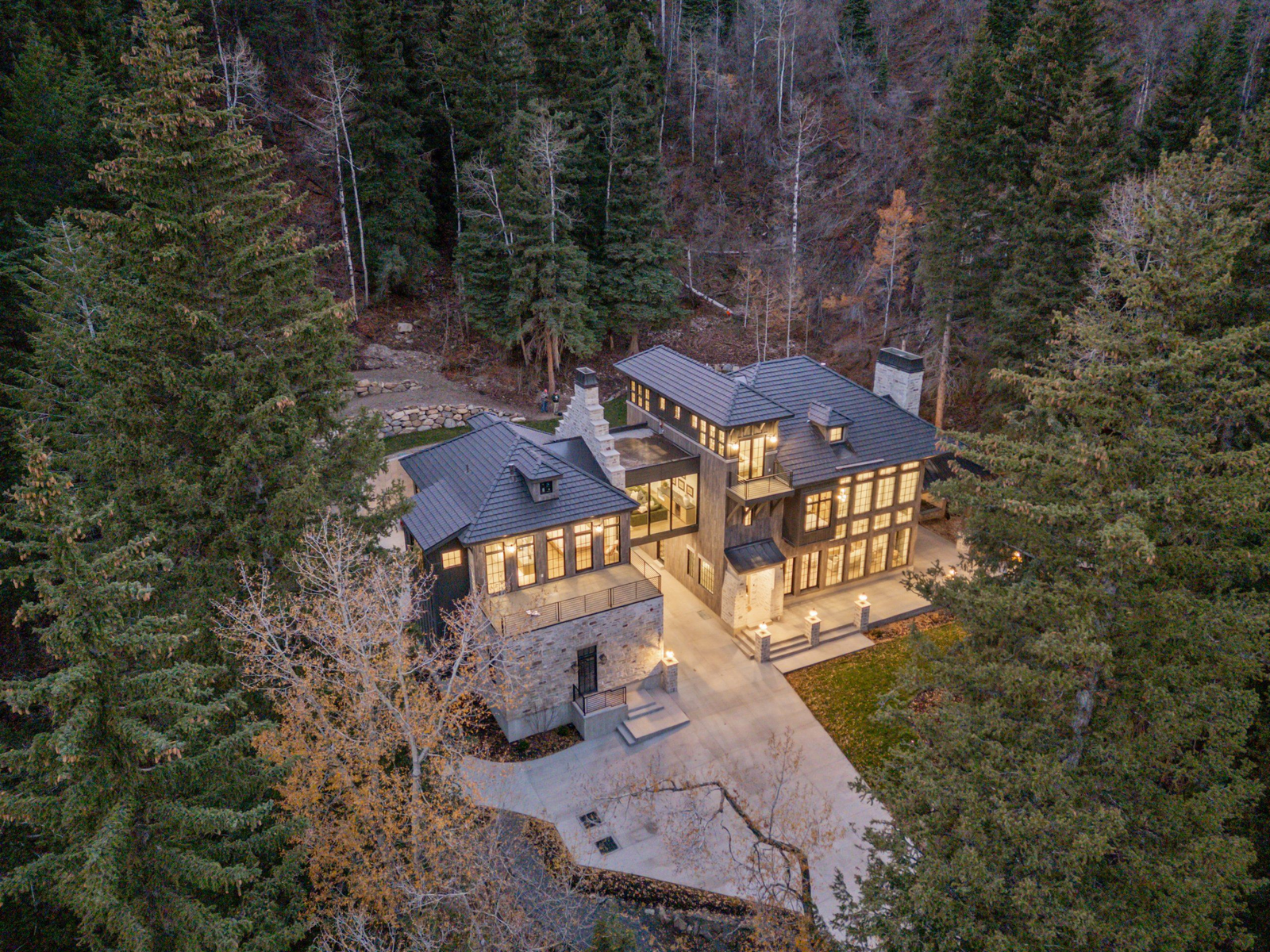 River-Crossed Alpine Estate exterior with mountain and forest setting