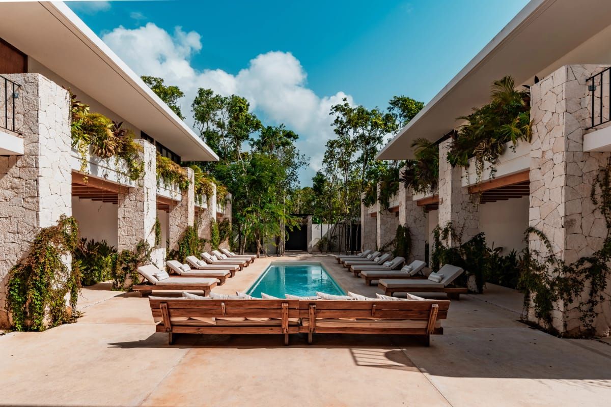 Pool courtyard at a private estate with guest suites on both sides