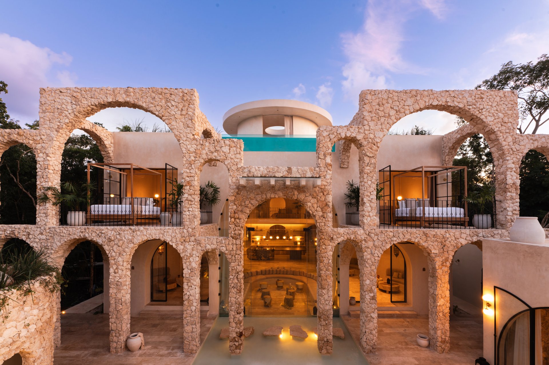 Luxury Mediterranean-style wedding venue with stone arches and ambient lighting